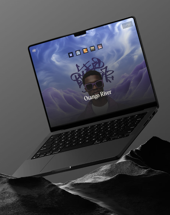 Laptop displaying "Otango River" website on rocks